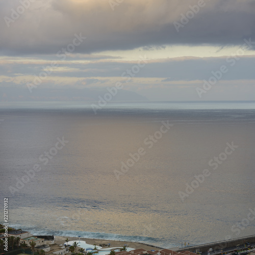 Blurred sunshine reflections in ocean and clouds over Canary Islands.