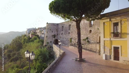 Antico castello Feudale difensivo con torre e mura di un piccolo borgo cittadino sulle montagne che si affaccia dal Mediterraneo. Ardore, vista aerea.  photo