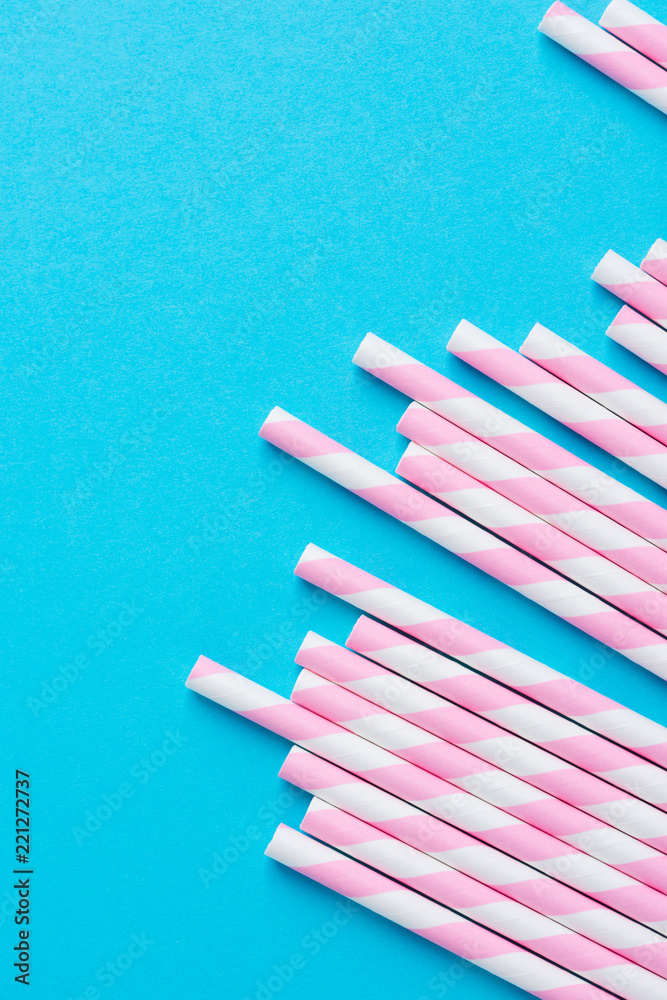 Obraz premium Bunch of Elegant White Pink Striped Paper Drinking Straws on Mint Blue Background. Birthday Party Babyshower Invitation Card Fun Kids Holiday Celebration Concept