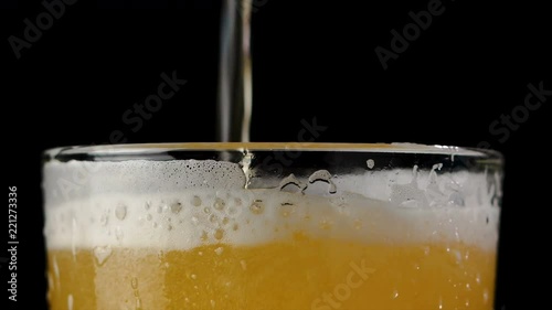 Wallpaper Mural 4K Slow motion beer pouring into the glass with foam bubble against dark background Torontodigital.ca
