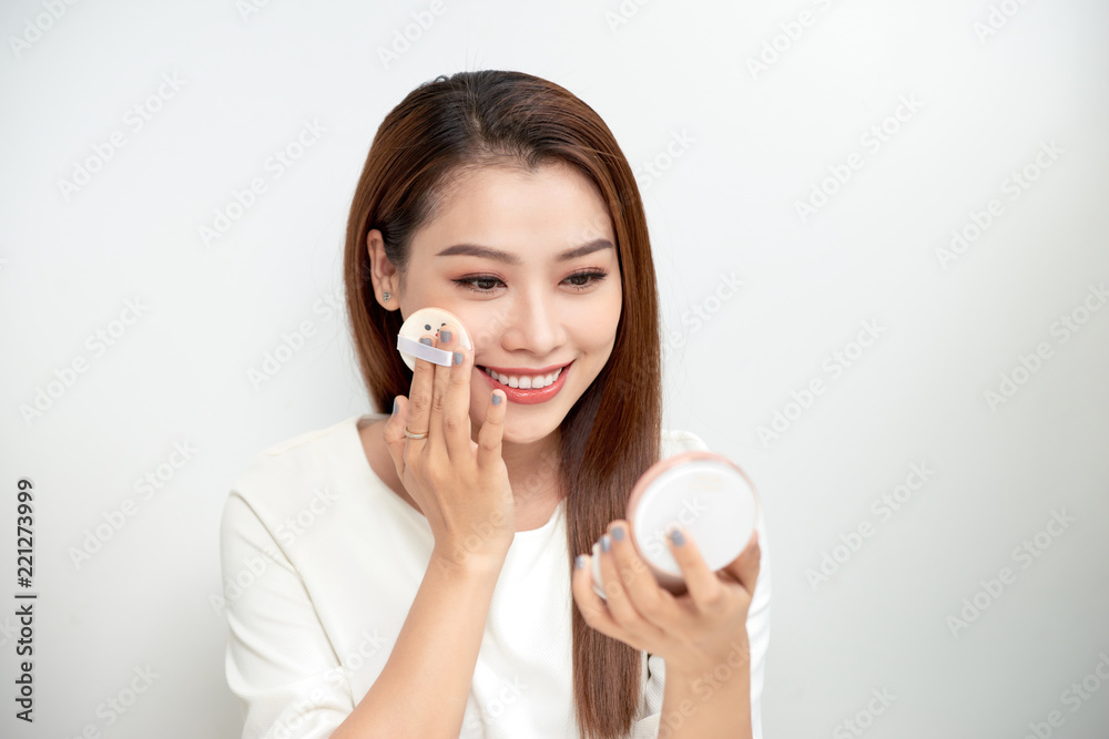 Face Make-Up. Closeup Of Sexy Female Applying Dry Powder Foundation Looking In Mirror. Portrait Of Young Woman Putting Makeup Powder With Cosmetic Cushion On Her Facial Skin Indoors. High Resolution Face Make-Up. Closeup Of Sexy Female Applying Dry Powder Foundation Looking In Mirror. Portrait Of Young Woman Putting Makeup Powder With Cosmetic Cushion On Her Facial Skin Indoors. High Resolution