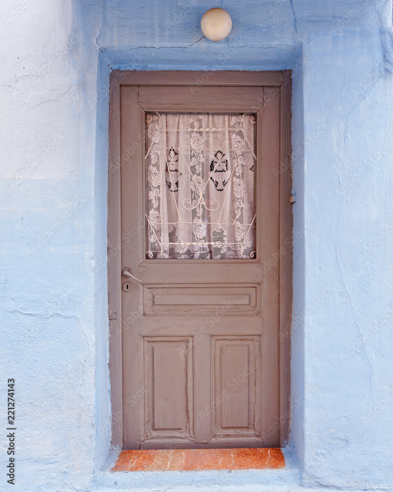 Greek island, brown door and blue wall Greek island, brown door and blue wall