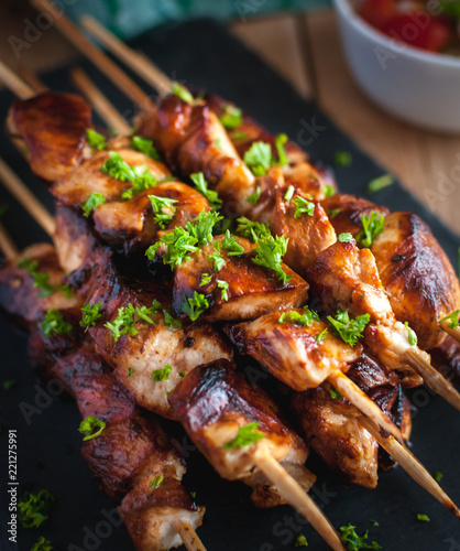 Close-up of homemade honey and beer BBQ chicken skewers with fresh parsley photo