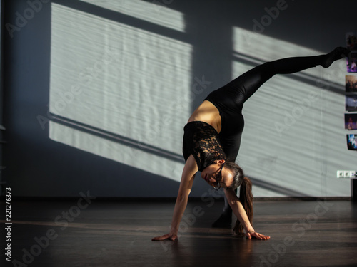 Photography A young girl is engaged in jazz modern dance in the hall.