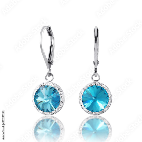 beautiful blue diamon earrings with reflection on white background