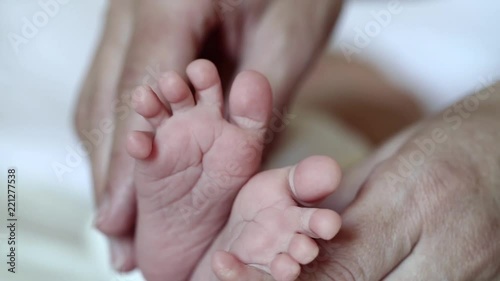 Wallpaper Mural Mother hands with baby feet. One months old baby boy. Mom holds little baby feet in the hands Torontodigital.ca