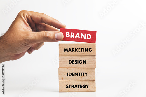Businessman Building BRAND concept with Wooden Blocks