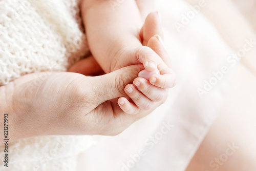 Newborn baby feet on knitted plaid. Closeup picture with copy space.Close up image.