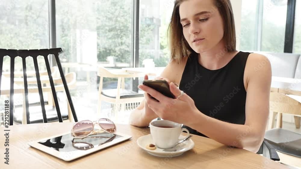 Young woman in business suit talking on mobile phone. Young woman in business suit talking on mobile phone.