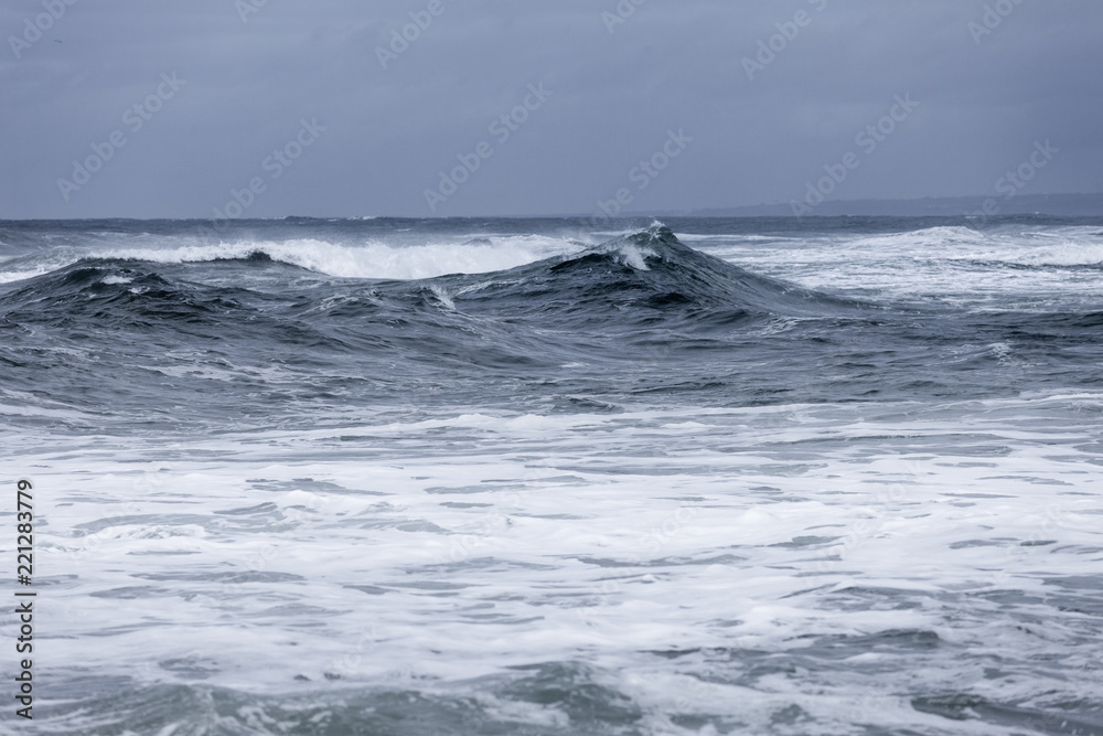 Stormy clouds and crashing ocean waves during storm in the atlantic ocean