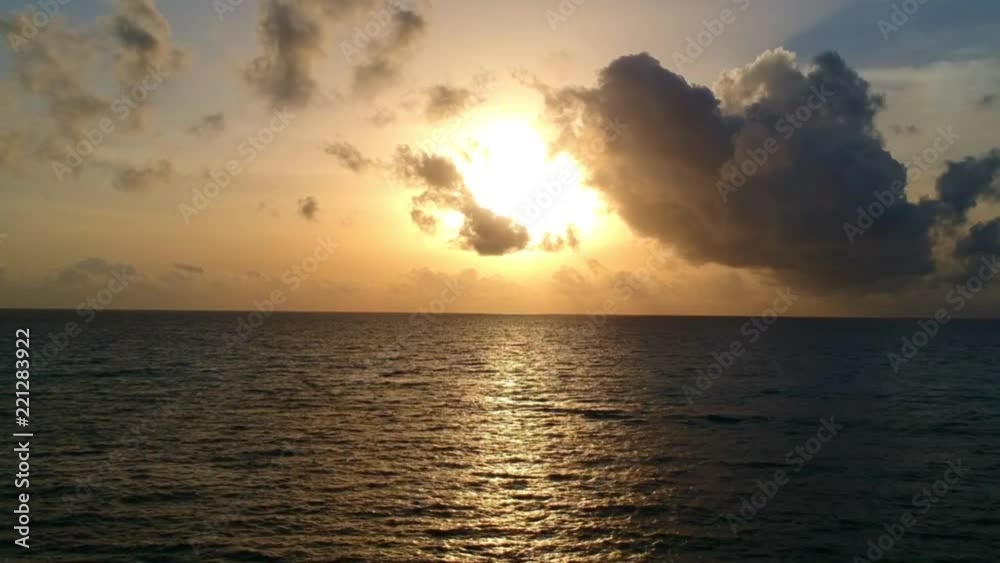 Aerial shots of the sunset and a speedboat driving along the horizon Aerial shots of the sunset and a speedboat driving along the horizon