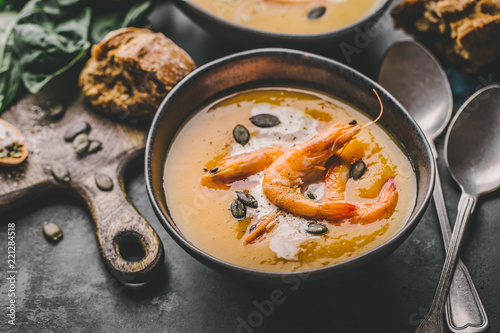 Autumn pumpkin creamy soup in bowls