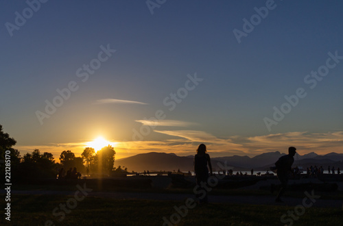 Person enjoying sunset  Kitsilano Beach Park  Vancouver  BC  Canada.