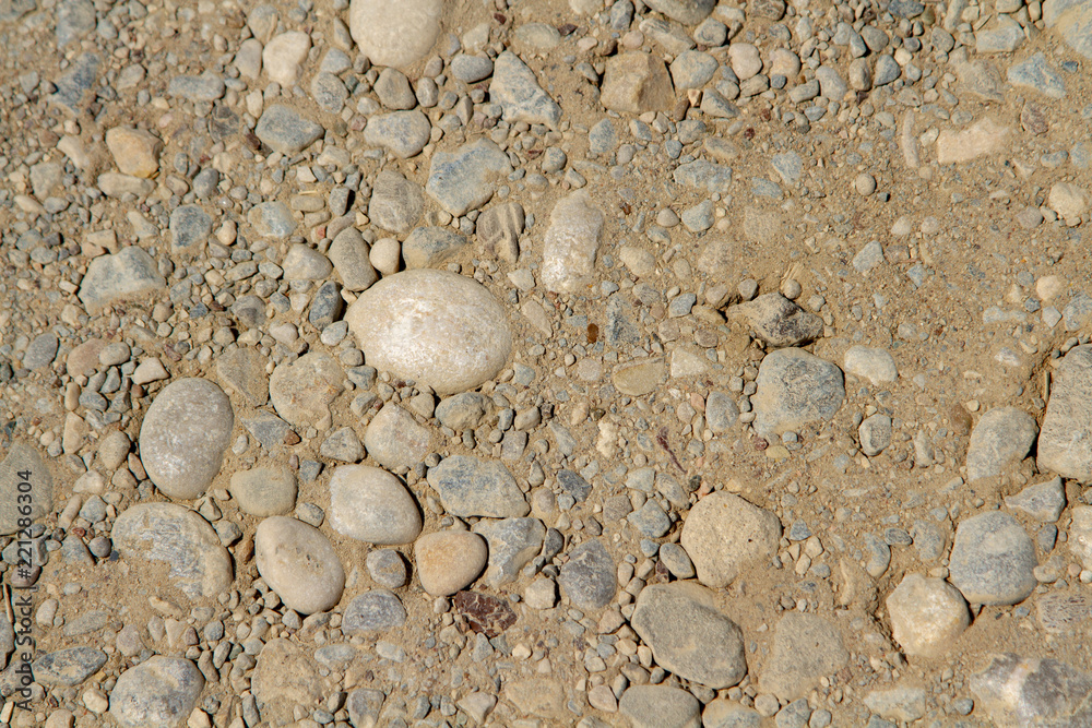 The texture of a highway in a desert maze for use as a background. A large fraction of the stone. Fine fraction of stone. The middle fraction of the stone. Close-up. The texture of a highway in a desert maze for use as a background. A large fraction of the stone. Fine fraction of stone. The middle fraction of the stone. Close-up.