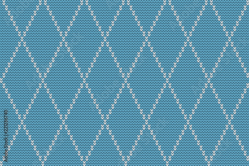 Seamless knitted pattern with white rhombuses on a blue background. Checkered winter background. Vector illustration