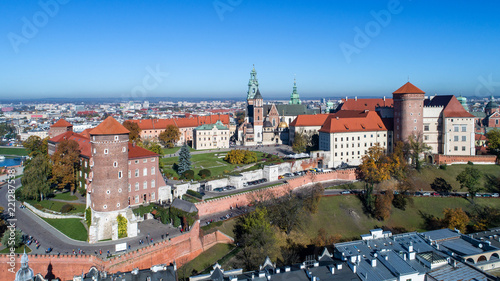 Royal Wawel Gothic Cathedral in Cracow, Poland, with Renaissance Sigismund Chapel with golden dome, Wawel Castle, yard, park and tourists. Aerial view in autumn.