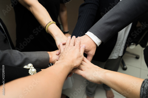 Business team work concept. Business people joining hands © Thammasiri