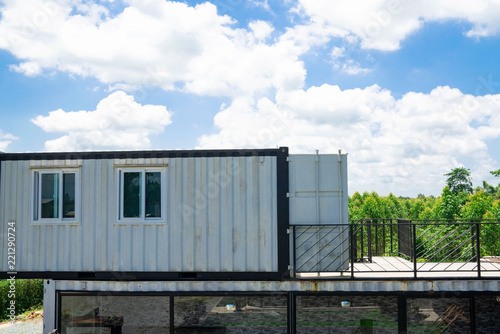 Modern metal building made from shipping house containers and blue sky background .