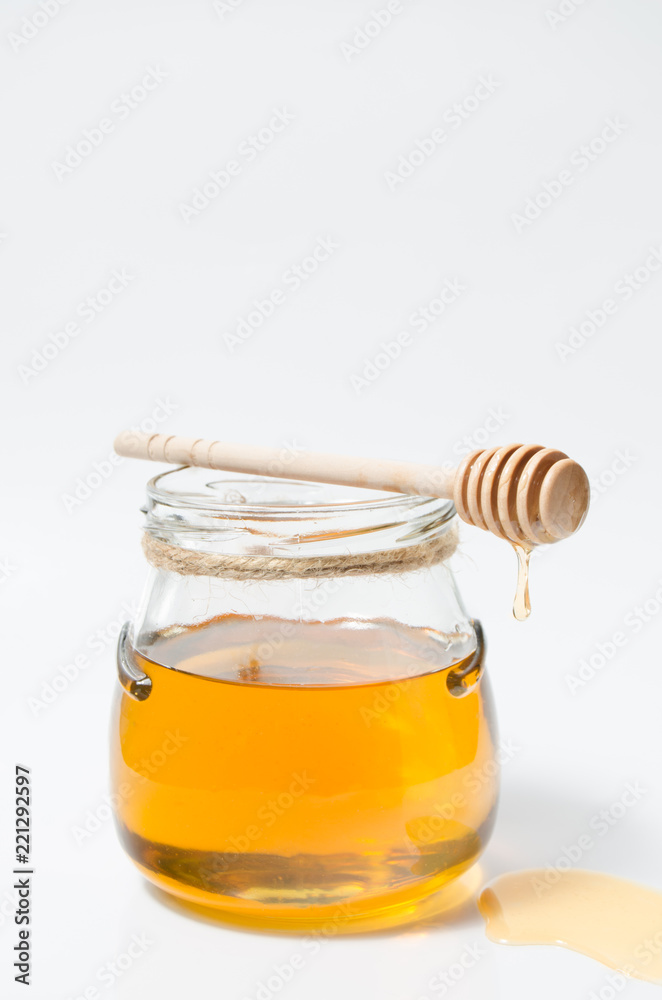 Natural fresh honey and honey spoon on white background. Natural fresh honey and honey spoon on white background.