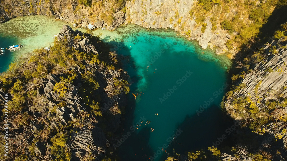Aerial view: Twin Lagoon with blue, azure water in the middle of small islands and rocks. Beach, tropical island, sea bay and lagoon, mountains with forest, Palawan, Coron. Busuanga. Seascape