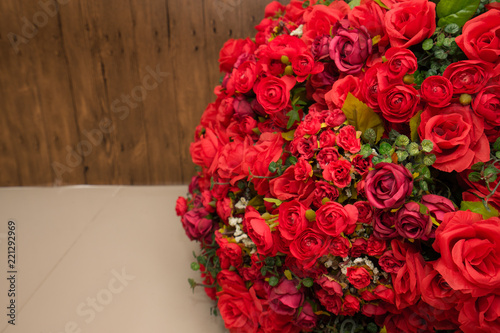 Fototapeta Naklejka Na Ścianę i Meble -  Red rose fake flower and Floral background. rose flowers made of fabric. The fabric flowers bouquet. Colorful of decoration artificial flower