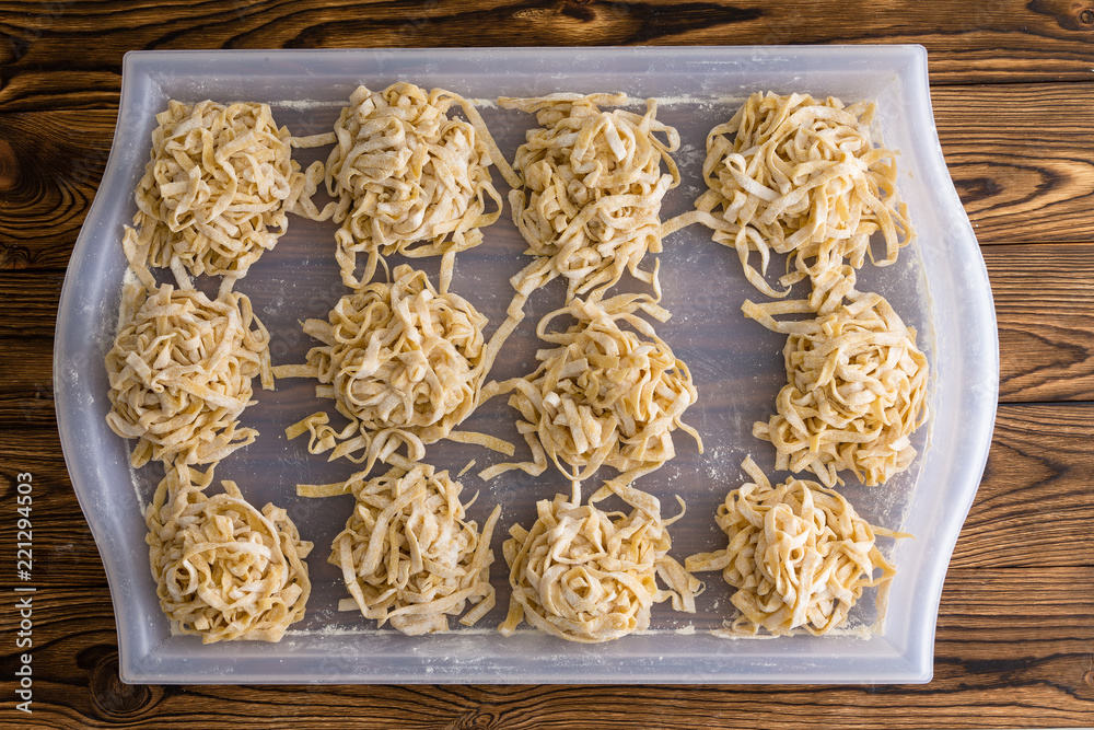 Bundles or portions of fettuccine pasta drying Bundles or portions of fettuccine pasta drying