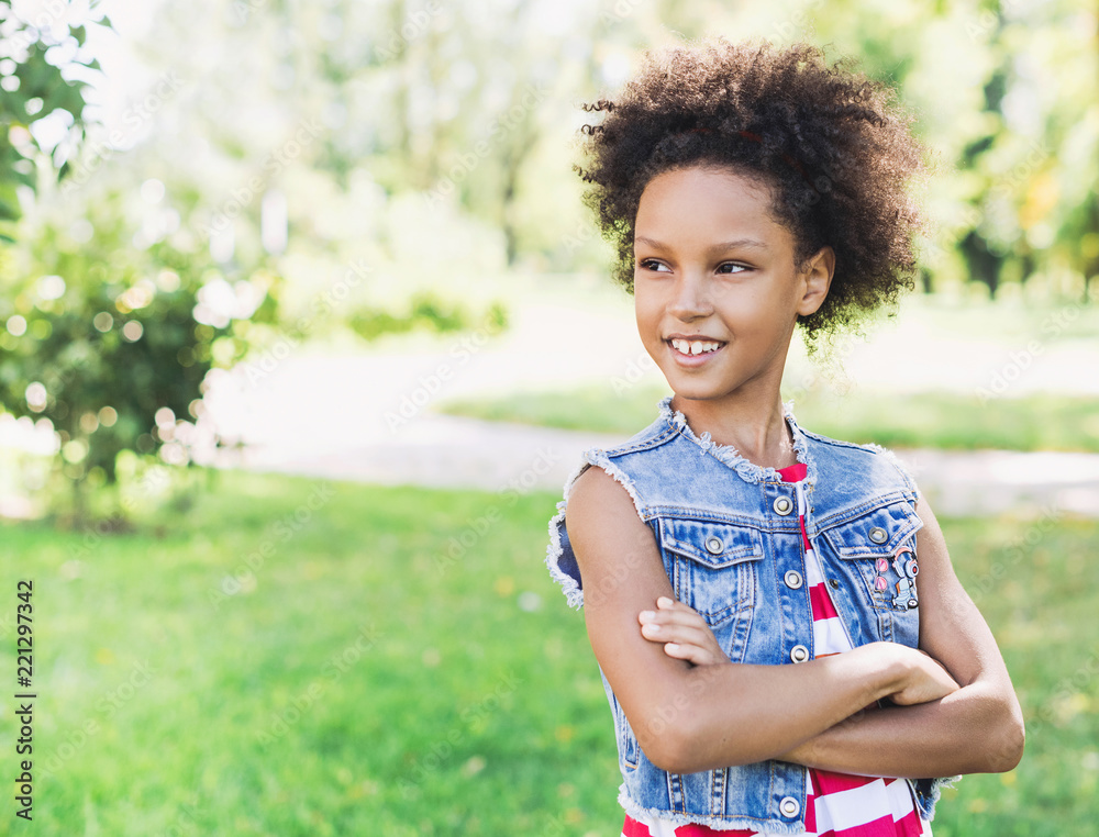 Beautiful kid girl portrait outdoors.  Healthy smiling little girl enjoying life.  Relaxing in nature, summer holidays concept