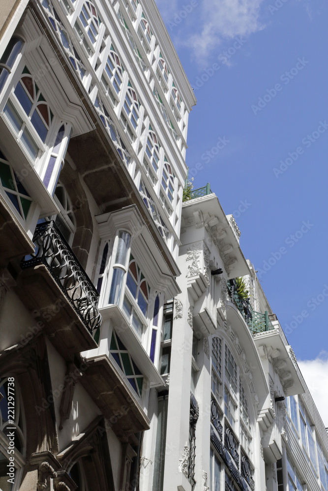 Typical Galician galerias, white enclosed balconies made of wood and glass, in the capital city La Coruña