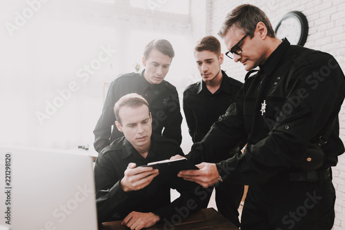 Officer Instructs Subordinates In Police Station.