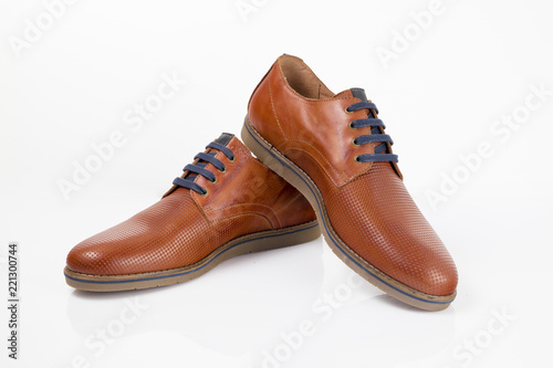 Brown leather shoe on white background.