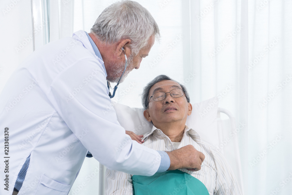 Senior doctor used stethoscope to hearing patient heart beat Senior doctor used stethoscope to hearing patient heart beat