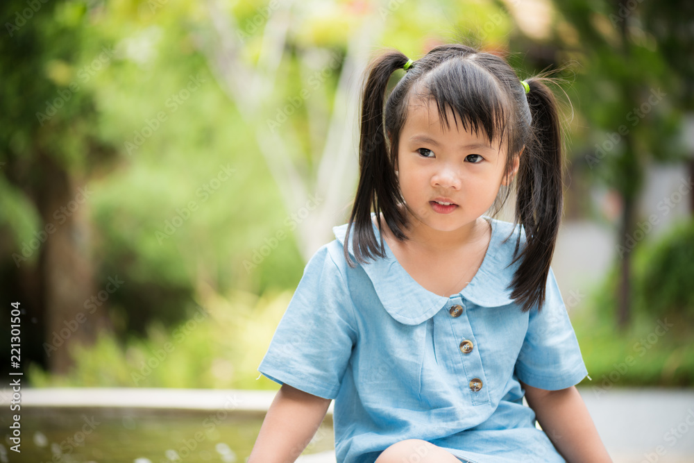 Happy little girl playing water in colorful garden on hot summer day. Summer activities for kids. Happy little girl playing water in colorful garden on hot summer day. Summer activities for kids.