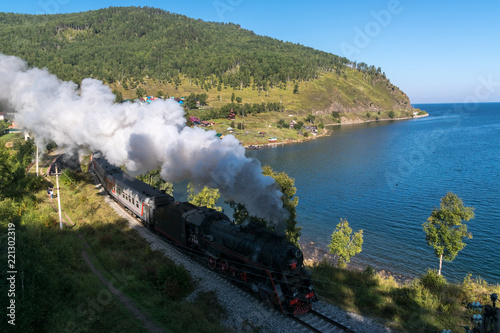 The old steam locomotive is driving along the Circum-Baikal Railway