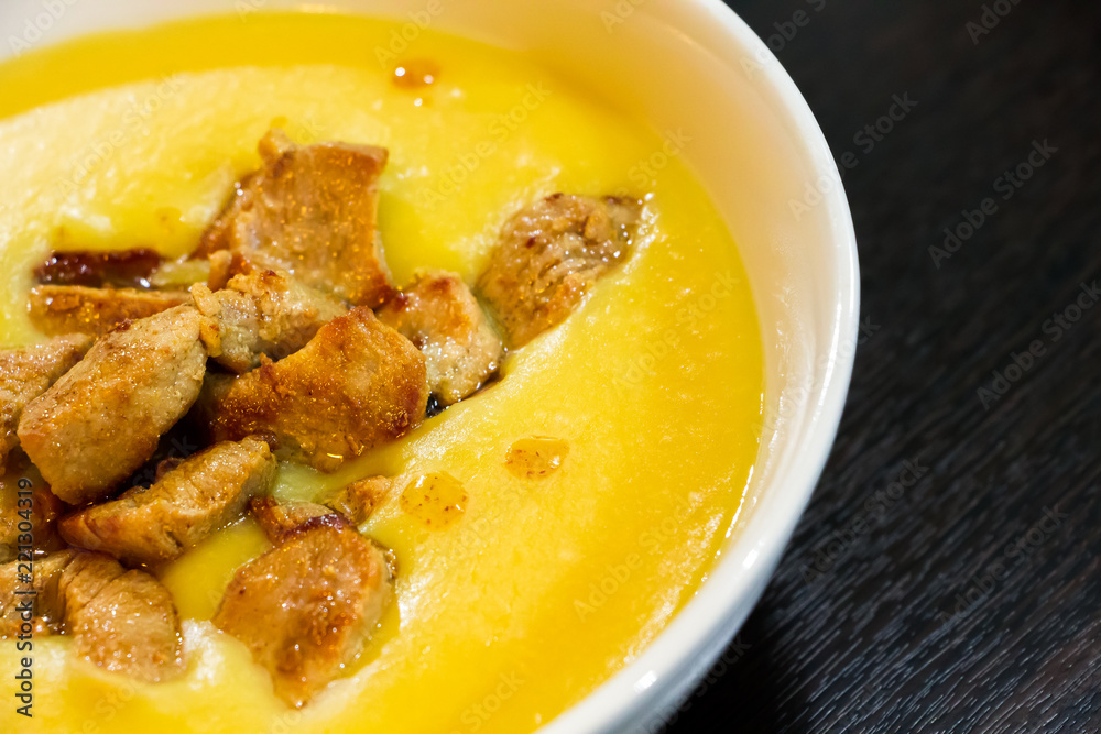 Yellow cream soup of beans with roasted meat