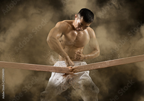  karate man breaking with hand wooden board