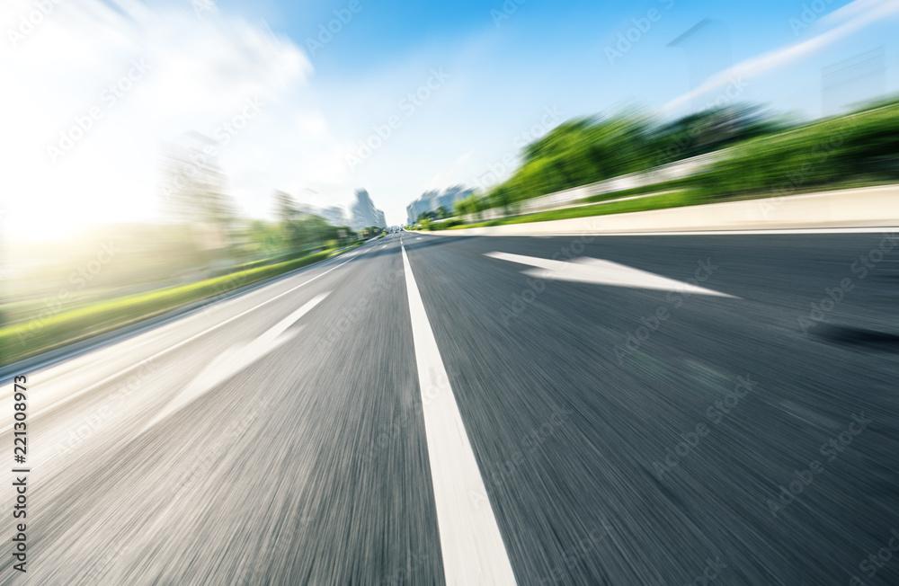 empty asphalt road with city skyline