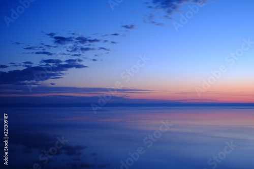 Fototapeta Naklejka Na Ścianę i Meble -  Beautiful sunset over sea with reflection in water.