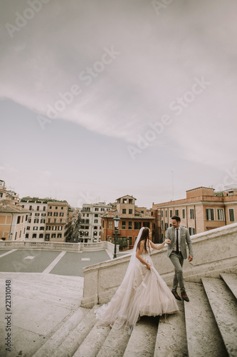 Young wedding couple on Spanish stairs in Rome, Italy
