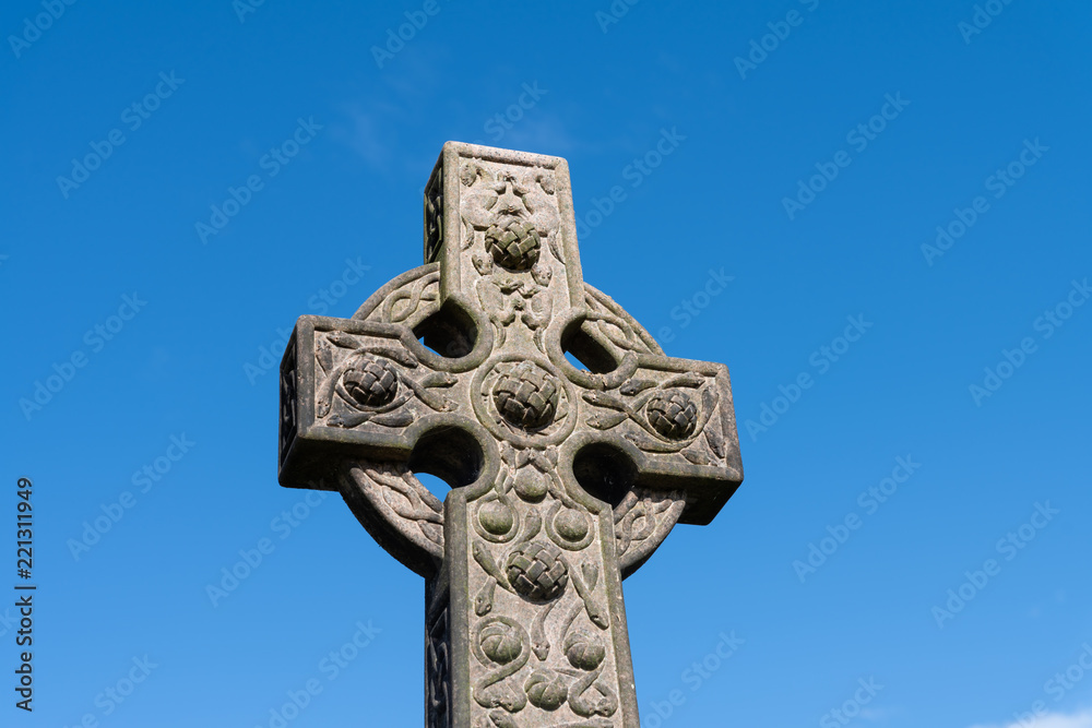 The top of a fine carved Celtic Cross gravestone memorial close to Stirling Castle in Scotland. The top of a fine carved Celtic Cross gravestone memorial close to Stirling Castle in Scotland.