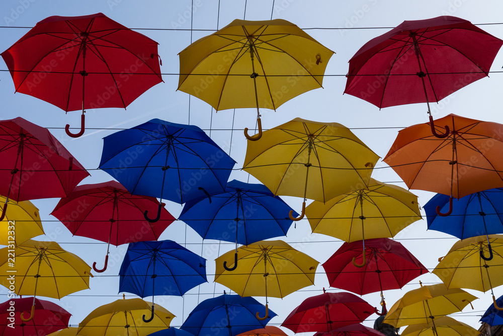 Obraz premium Colorful umbrellas against the blue sky at the street festival
