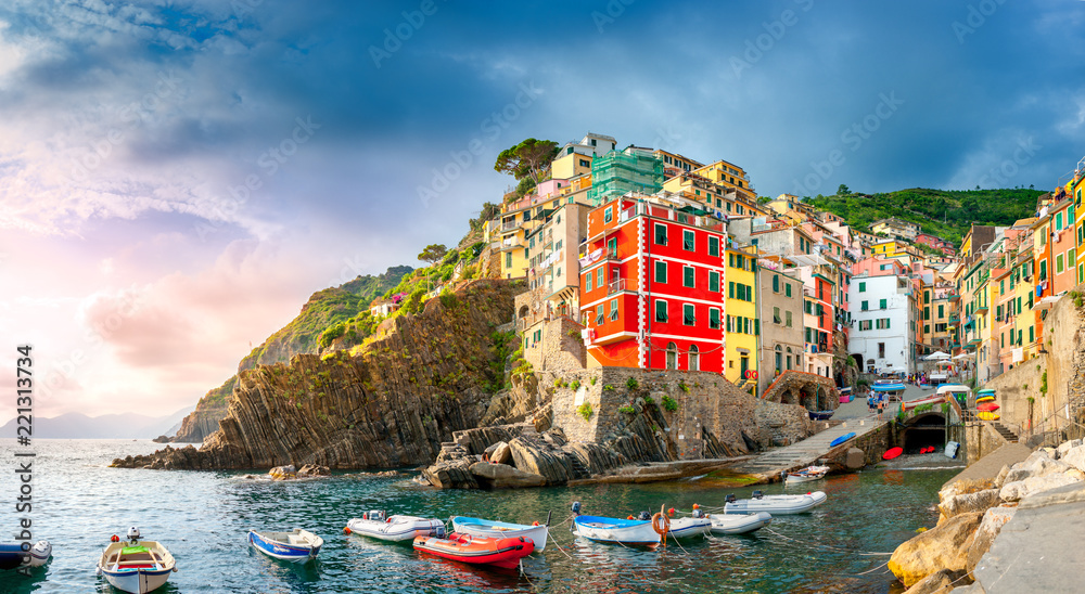 panorama of the famous Italian seaside viilage Riomaggiore at sunset, Cinque Terre. Italy