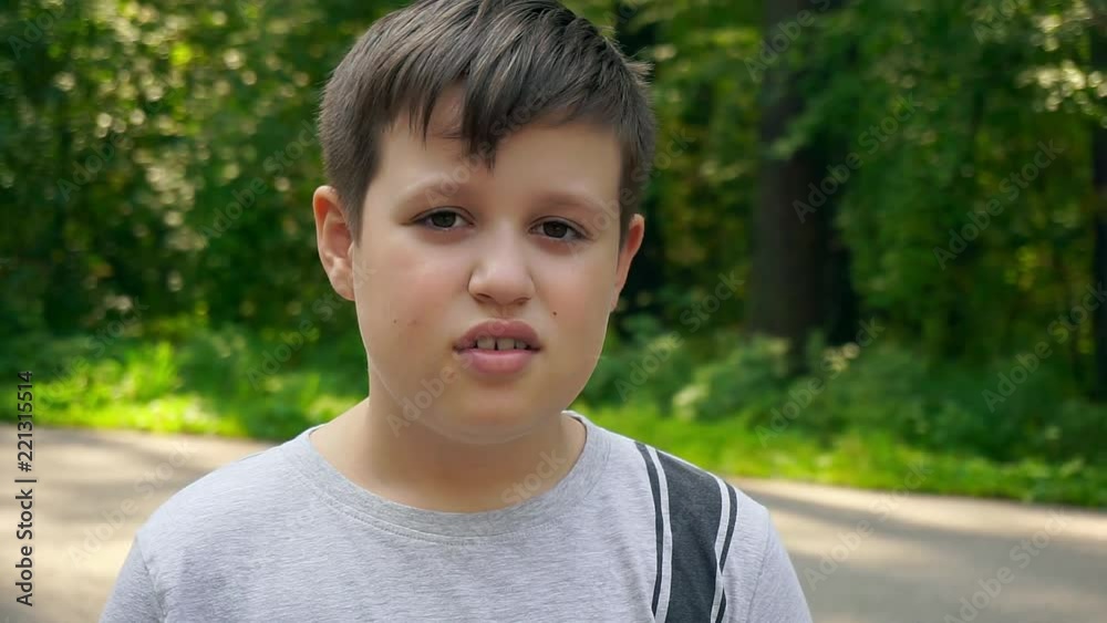 Sad boy looks at the camera. Portrait of sad child looking at the camera Sad boy looks at the camera. Portrait of sad child looking at the camera