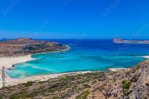 Balos lagoon (Balos beach) on Crete island. Tourists relax and bath in crystal clear water of Mediterranean Sea, Greece.