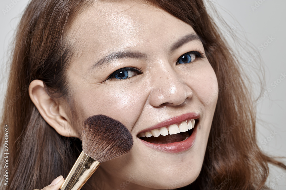 woman applying cosmetic powder brush woman applying cosmetic powder brush