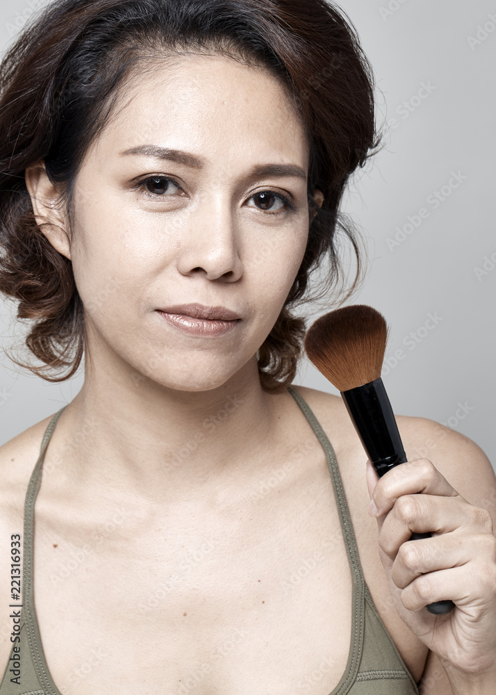 Woman applying cosmetic powder brush Woman applying cosmetic powder brush