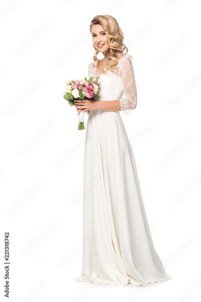 happy bride holding bouquet and looking at camera isolated on white