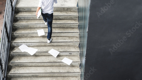 businessman hurrying time with papers document on ground