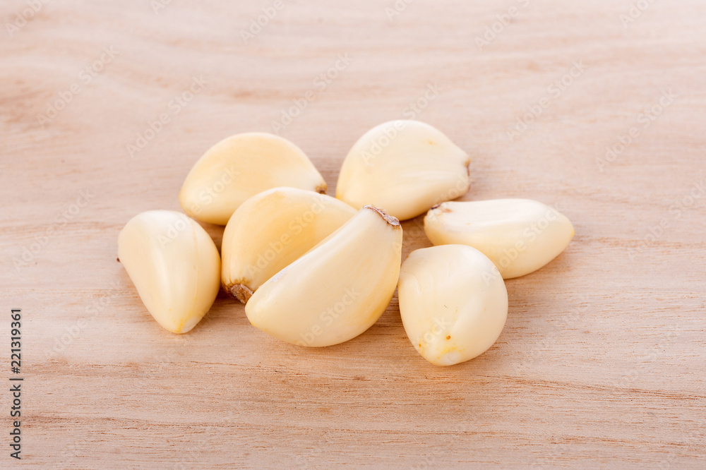 Garlic isolated on wooden background