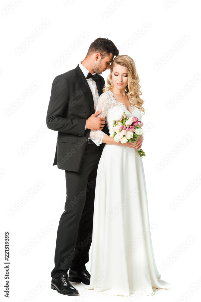 beautiful young bride and groom cuddling isolated on white beautiful young bride and groom cuddling isolated on white