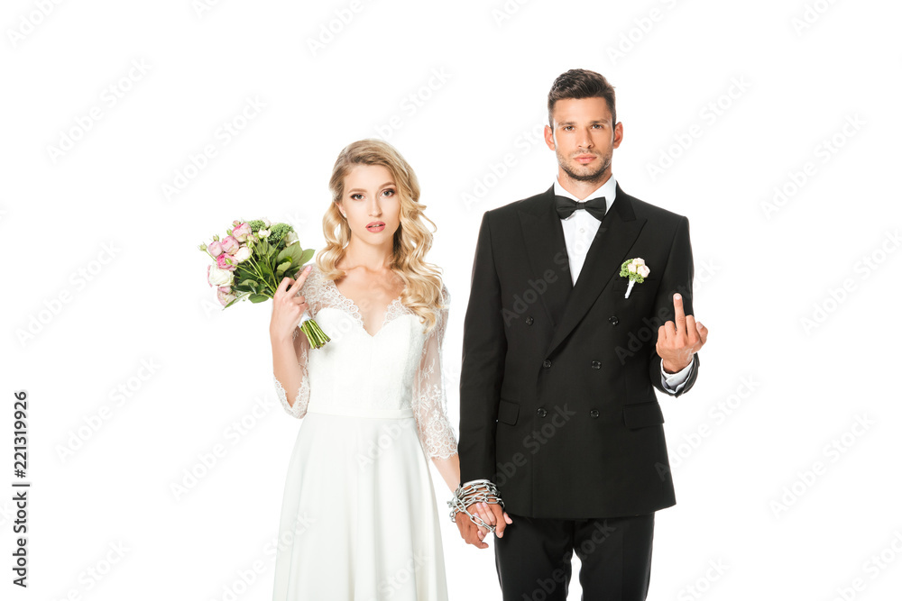 young bride and groom holding hands and showing middle fingers at camera isolated on white young bride and groom holding hands and showing middle fingers at camera isolated on white